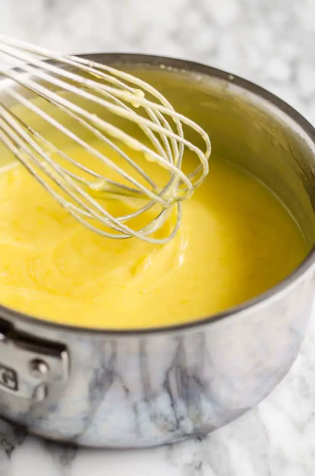 Lemon curd mixture is cooked to a pudding like consistency for making Goldilocks Kitchen Lemon Bars - The Goldilocks Kitchen