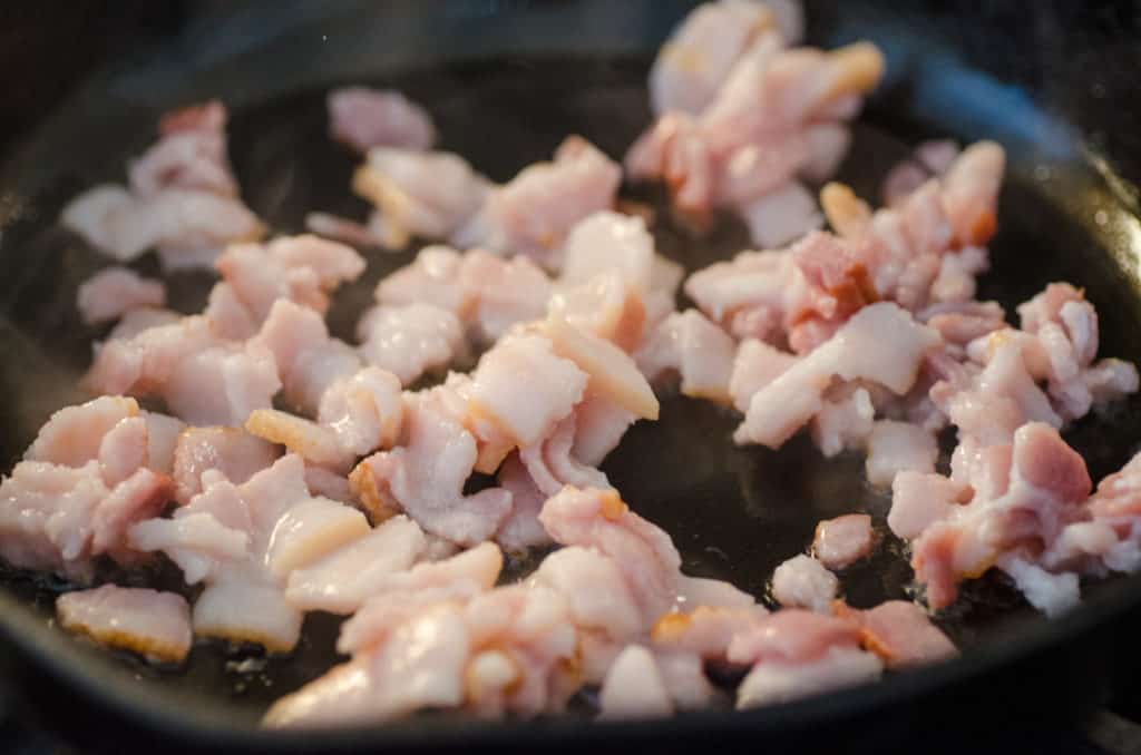 Premium Photo  Grilling bacon strips on cast iron griddle in