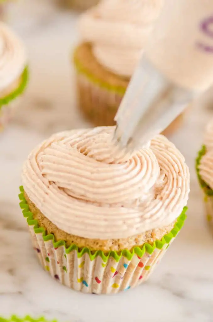 Cinnamon Buttercream Frosting being piped onto a cupcake- The Goldilocks Kitchen
