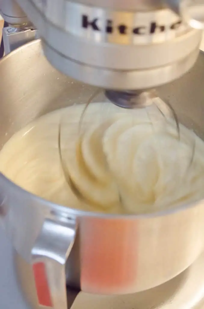Cooked egg whites are whisked at high speed by a stand mixer to help them cool to make French Silk Pie without Raw Eggs - The Goldilocks Kitchen