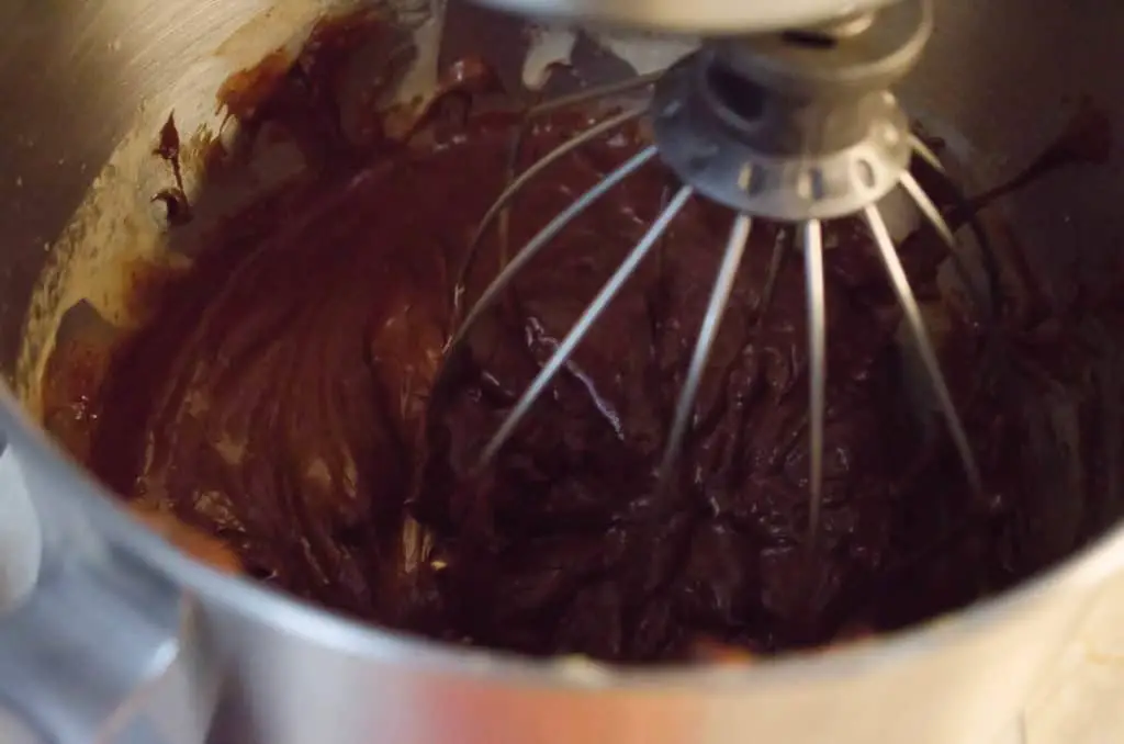 Egg whites and melted chocolate are whisked together by a stand mixer to make French Silk Pie without Raw Eggs - The Goldilocks Kitchen
