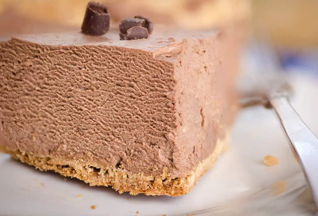 Closeup picture of a wedge slice of French Silk Pie without Raw Eggs showing the velvety chocolate texture- The Goldilocks Kitchen