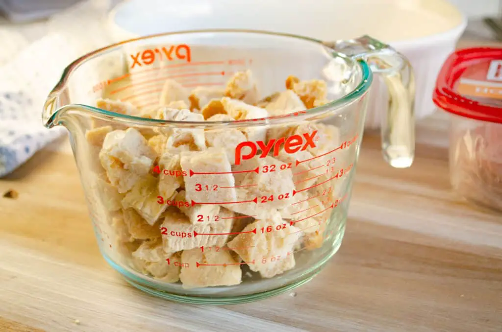 A measuring cup full of Tyson Grilled and Ready Oven Roasted Diced Chicken.