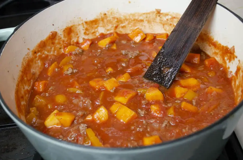 Green Chile Squash Goulash cooks in a stovetop Dutch oven.
