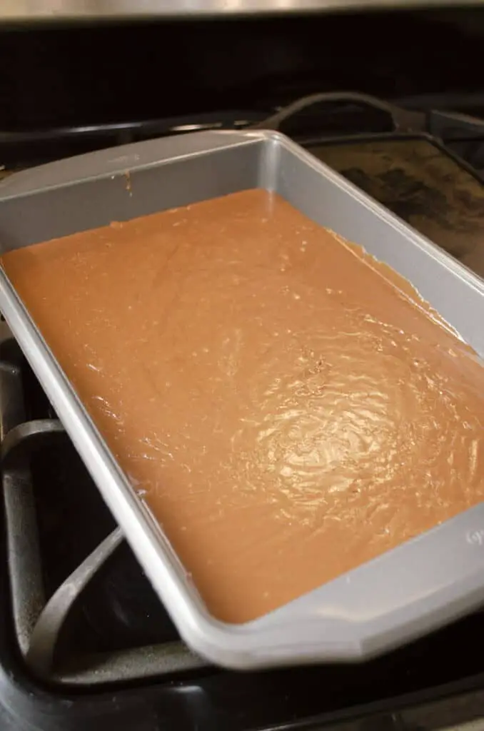 A non-stick 9x13 inch pan is filled with cooling chocolate Blue-Ribbon Fudge.
