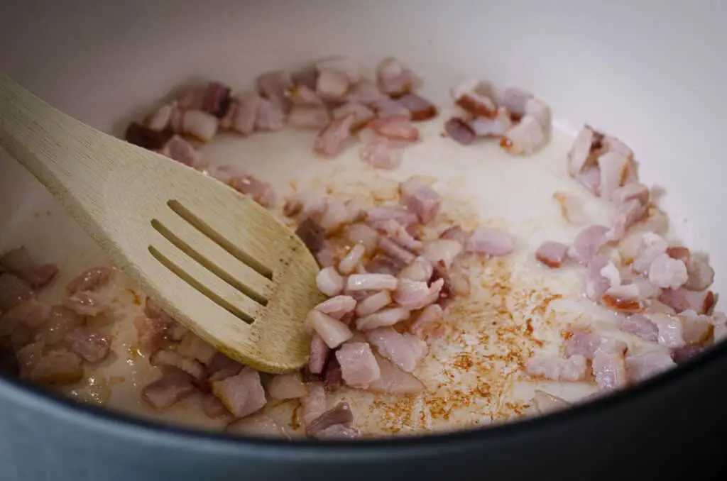 Chopped bacon is sauteed in a dutch oven .