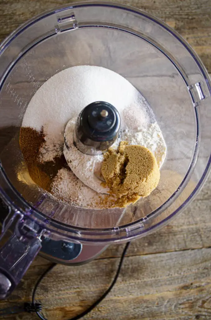 Looing down into the bowl of a food processor filled with the ingredients for the Ginger-Pear Crisp topping.