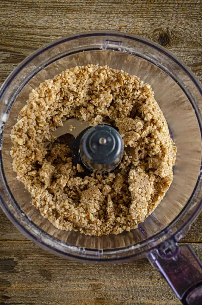 Ginger-Pear Crisp topping blended with pecans in the bowl of a food processor.