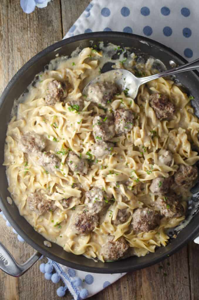 Looking down on a skillet full of 30-minute One-Pot Meatball Stroganoff (Meatballs and noodles in sauce).