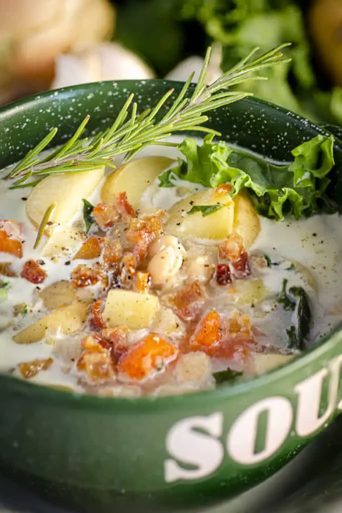 A closeup of a bowl of Winter Slow-Cooker Vegetable Bacon Soup showing the hearty texture.