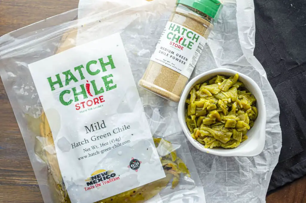 Looking down at Hatch Chile store products, such as a 1 lbs bag of Mild hatch green chile, chopped, and a container of Hatch Green Chile Powder.