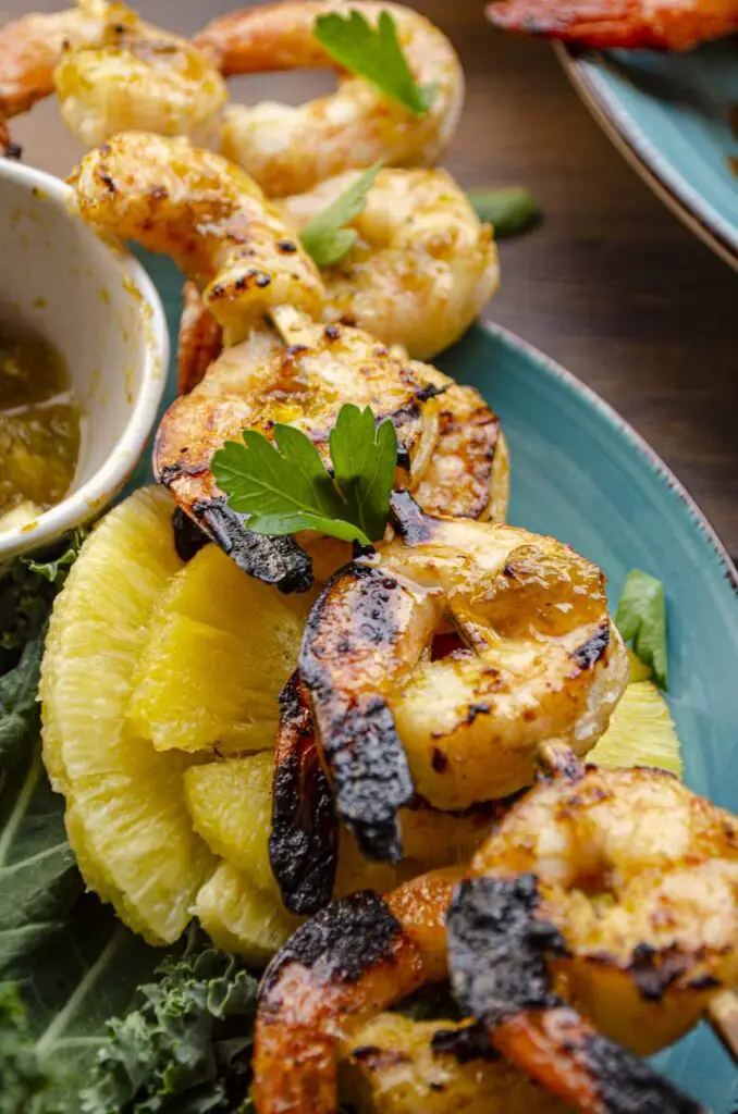 A closeup of barbecued shrimp on a skewer glazed with Sweet and Spicy Hatch Chile Glaze. (Green chile)