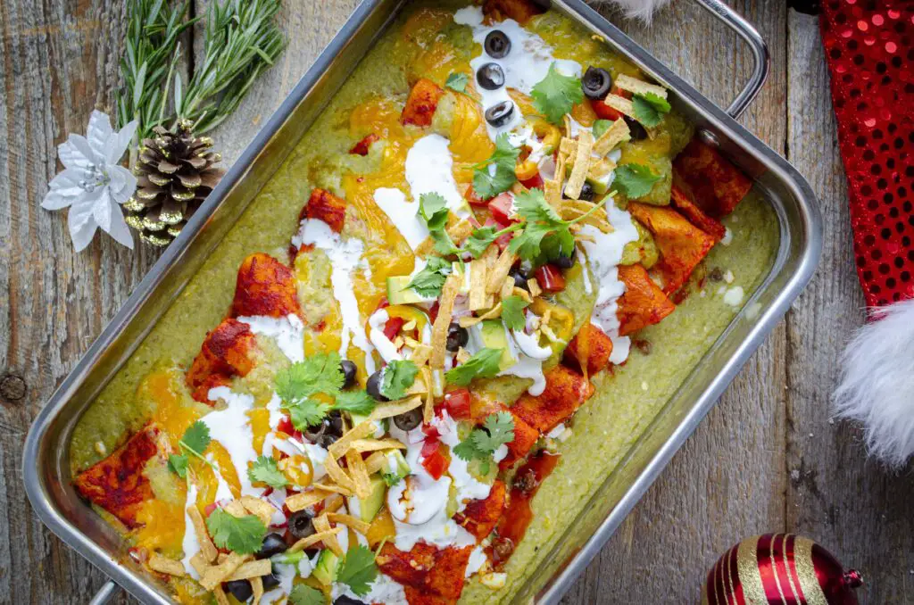 Looking down into a dish of Christmas style New Mexican Enchiladas.