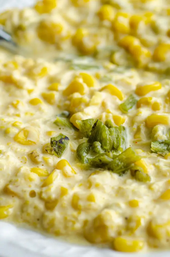 A closeup of Creamed Corn with chopped green chiles mixed in.