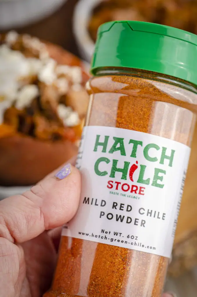A bottle of Mild red chile powder from the Hatch Chile Store used to season the steak picado.