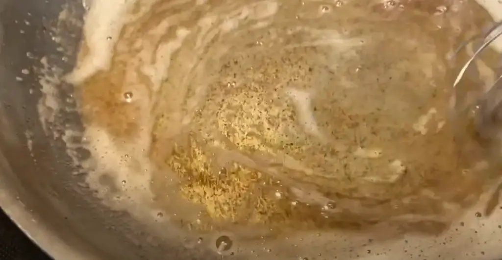 A closeup of browned butter in a skillet.